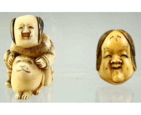 A JAPANESE CARVED IVORY NETSUKE of a seated boy playing with a rabbit, together with a miniature noh mask; signed, 3.5cm and 