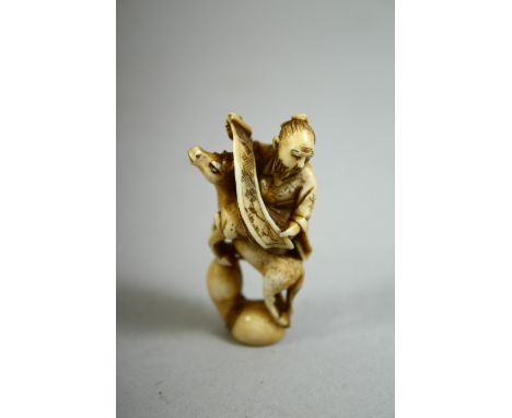 A JAPANESE CARVED IVORY NETSUKE of a sage holding a scroll seated on a rearing horse, signed to the base, 5cm high.