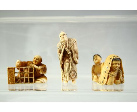 THREE JAPANESE CARVED IVORY NETSUKES, including a standing figure holding a sword, a carpenter and a netsuke of mythical crea