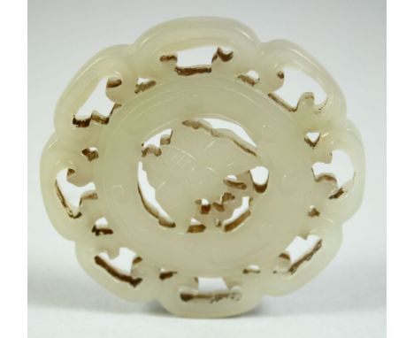 A 19TH CENTURY CHINESE CARVED AND PIERCED JADE AMULET, of circular form - the centre carved with a butterfly, 5cm diameter.