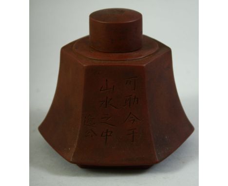 A CHINESE YIXING LIDDED TEA CADDY, with characters to the side, impressed mark to lid, 11.5cm high.