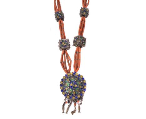 ϒA North African coral baton necklace, with a circular amulet pendant drop decorated with blue, green and yellow cloisonné en