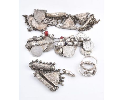 A pair of Bedouin earrings, in the halaq/khurs style, with hollow bead terminals with embossed and granulated decoration, det