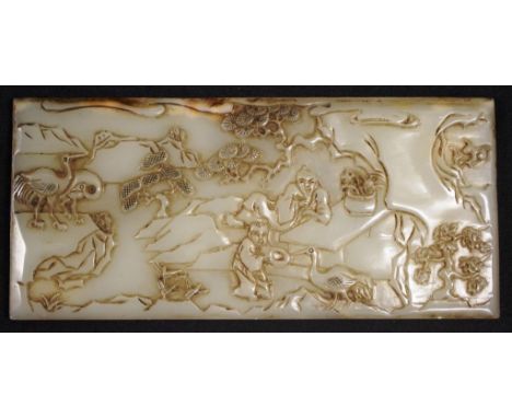 Chinese carved jade plaque showing carved figures in a garden setting, character marks verso, (8.5cm X 18cm approx).