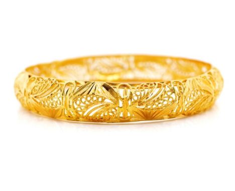 Yellow gold filigree bangle with partial marks. Approx width 12mm, 64mm, inside width, weight 23 grams. Tests as 21ct