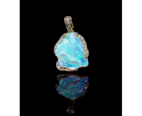 Carved opal, diamond and 18ct yellow gold enhancer marked 750. Opal of crystal type with green blue and flashed red orange. A