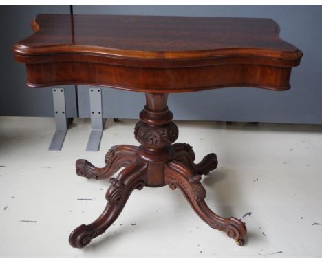 Victorian mahogany card table with fold over swivel top supported by a pedestal base with carved legs, 92cm wide, 74cm high a