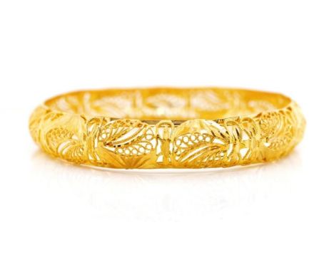 Yellow gold filigree bangle with partial marks. Approx width 12mm, 64mm, inside width, weight 23 grams. Tests as 21ct