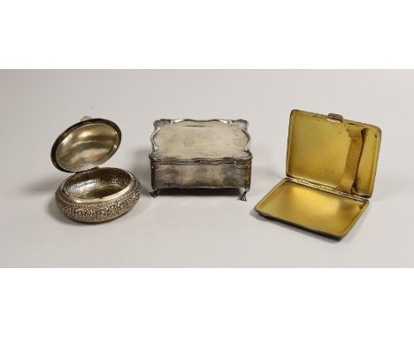 An Edwardian silver trinket box, Birmingham, 1907, 90mm, a silver cigarette case and a Persian? white metal oval box.