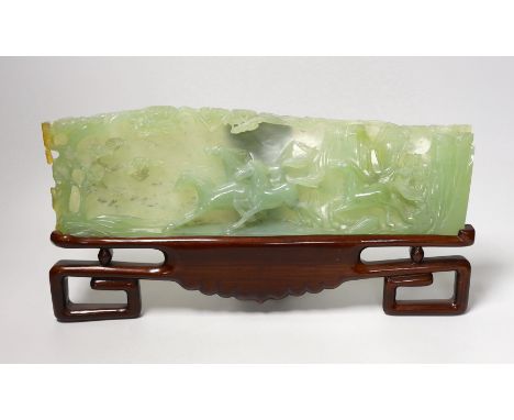 A large Chinese bowenite jade plaque of galloping horses, wood stand, 40cm wide