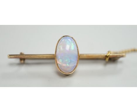 A yellow metal and single stone oval white opal set bar brooch, 39mm, gross weight 4.3 grams.