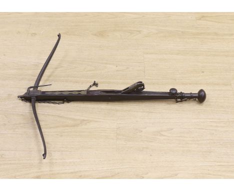 An 18th century English mahogany, brass and iron mounted bullet crossbow, 69cm, pommel end