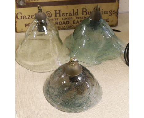 A group of three hand-blown glass light shades