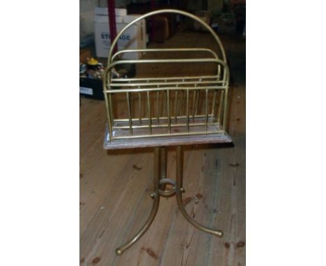 An Edwardian brass and walnut revolving magazine rack standard, set on tripod base