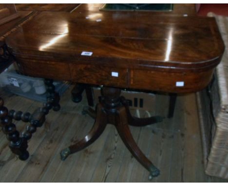 A 36" 19th Century flame mahogany and strung fold-over card table with later baise, set on turned pillar and quadruple splaye