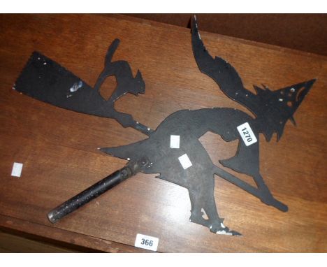 A painted metal weather vane in the form of a witch on a broomstick