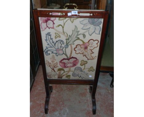 A Victorian walnut Chinese Chippendale style rise and fall fire screen with embroidered panel, set on flanking scroll support
