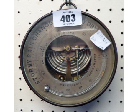 A 5 1/4" diameter 19th Century brass fob cased holosteric barometer/thermometer with visible aneroid works and suspender ring