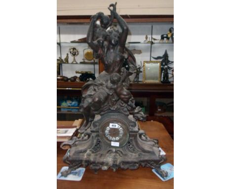 A 32" high Victorian ornate figural spelter cased mantel clock with classical female and two putti, enamelled numerals to dia