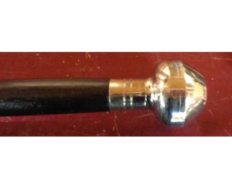 A modern reproduction walking cane with a compass to top