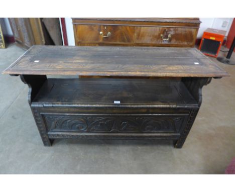 A carved oak monk's bench 