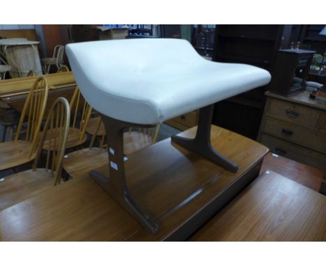 A teak and upholstered stool 