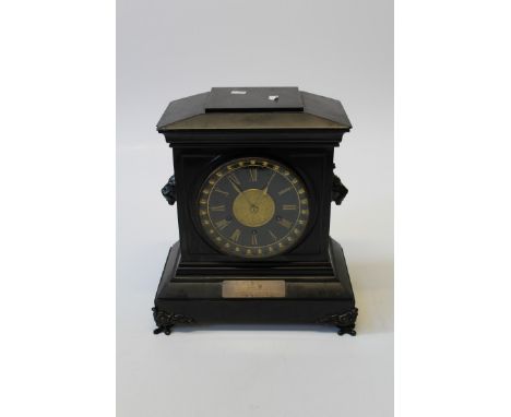 A late Victorian polished slate mantel clock of large size, having a two train movement striking on a gong, having a silvered