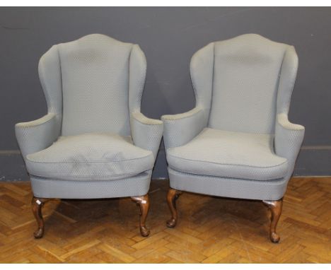 A pair of beech framed Queen Anne style wing armchairs upholstered in light patterned weave