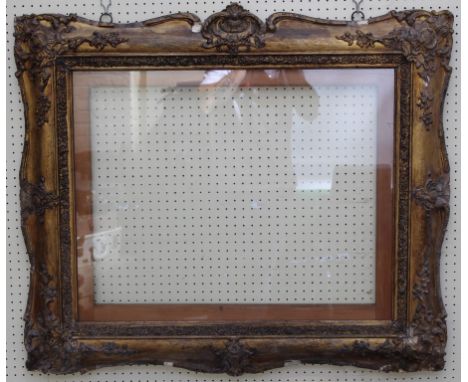 A Victorian giltwood and gesso portrait picture frame, with scallop and trailing bell flower decoration, 76 x 61cm (maximum i