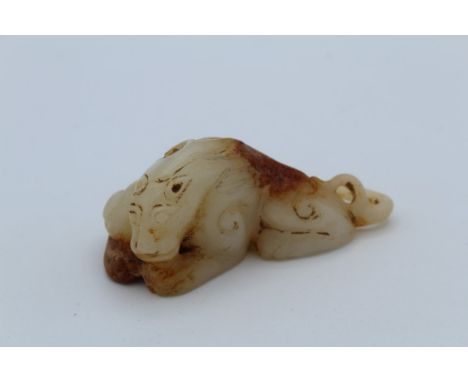 A Chinese carved jade model of a sleeping lion. 8.5cm long