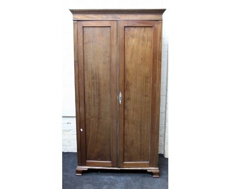 An Edwardian mahogany wardrobe, two panel doors, enclosing shelf and rail, on ogee bracket feet, 200 x 107 x 55cm