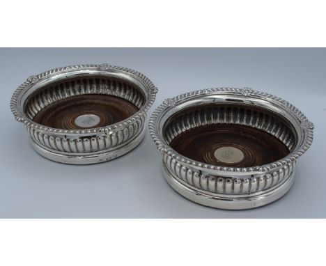 Paul Storr, a pair of George III silver bottle coasters, each with anthemion gadrooned rim, demi reeded body and circular foo