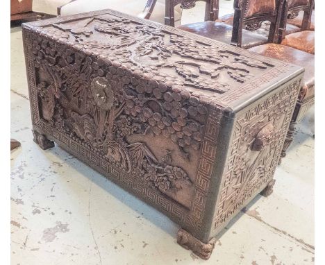 ORIENTAL CAMPHORWOOD TRUNK, early 20th century, all-over carved traditional designs, interior fitted a tray, 104cm W x 51cm D