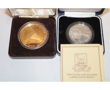 A 1982 sterling silver Liberation of the Falkland Islands crown, cased with certificate and a 1978 gilt "Man's First Atlantic