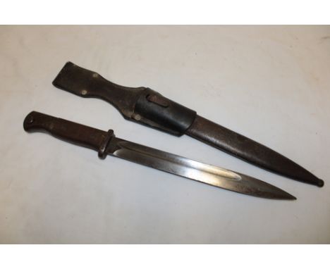 A Second War German Mauser bayonet with single edged blade marked "43ffc" in steel scabbard with leather frog dated 1939