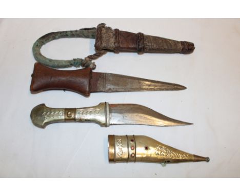 An African tribal dagger in leather scabbard and one other Eastern dagger (2)