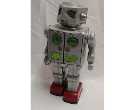 A Japanese tin plate battery operated robot by SH, 11½" high