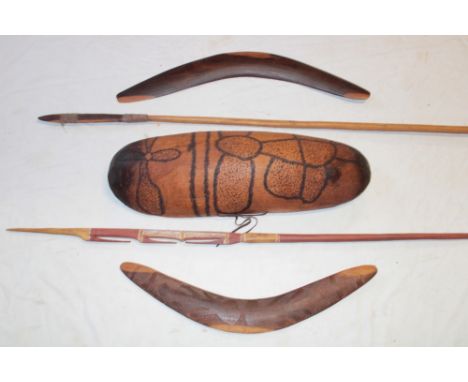 Two Australian aboriginal wood boomerangs, one with incised decoration, a long wooden spear, incised wood curved parrying shi