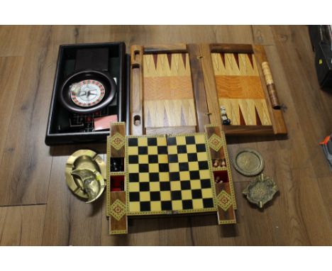 Three boxed roulette, backgammon, chess sets and four brass ashtrays 