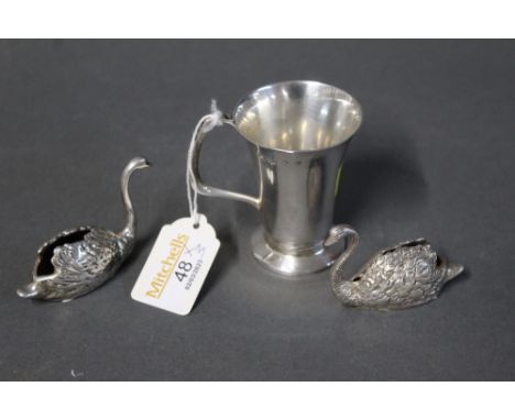 Small hallmarked silver cup, makers mark W R S Birmingham, date letter V, and two silver coloured swans  