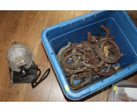 Miners helmet with lamp and battery pack and quantity of large vintage horseshoes 