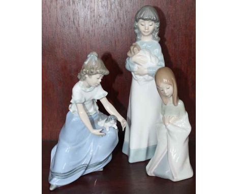 LLADRO FIGURE OF A KNEELING GIRL
and two Nao figures, each of a girl with a dog (3)