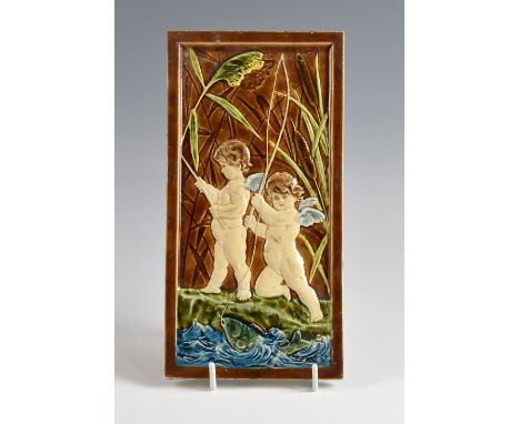  Villeroy & Boch, a tile depicting cherubs and a fish stamped VB to reverse, 18 x 31 cm.      Glazed area undamaged, some dir