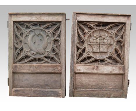 Two oak carved panels one depicting fish within a pierced,   surround, similar with basket of fruit, converted to be used as 