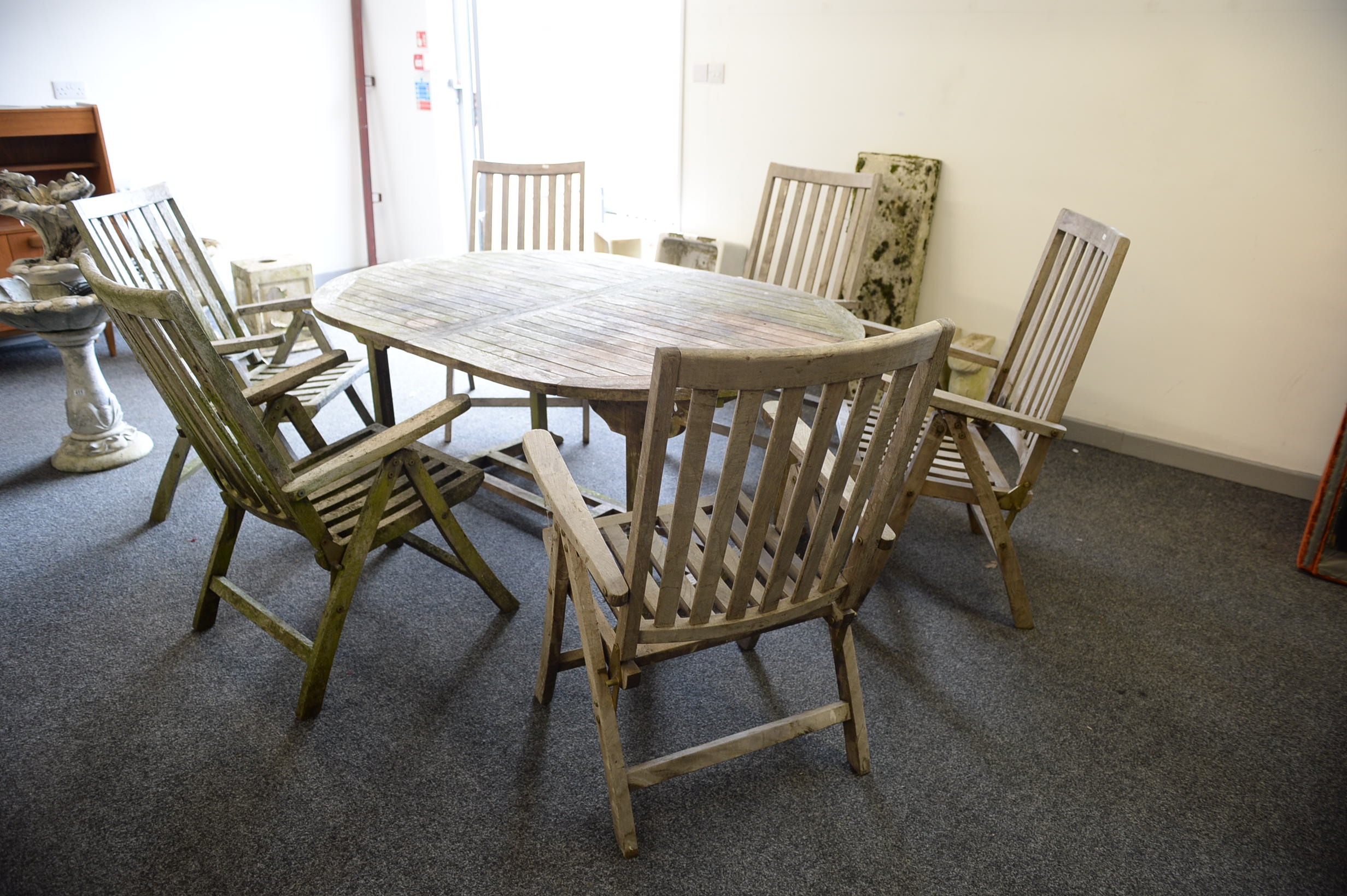 A GOOD TEAK EXTENDING GARDEN TABLE AND SIX CHAIRS. Top measures 180cm x