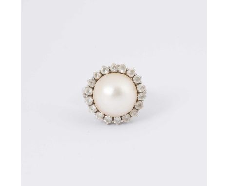 A cultured pearl and paste cluster ring, the large central pearl to a surround of eighteen paste stones, set in 18ct white go