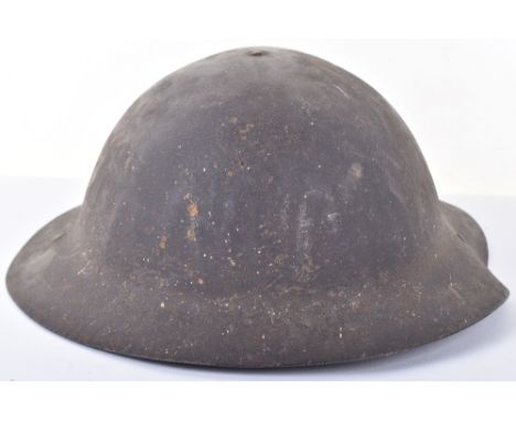 WW1 British Early Issue ‘B’ Pattern Steel Combat Helmet, good untouched example which has received a heavy blow from shrapnel
