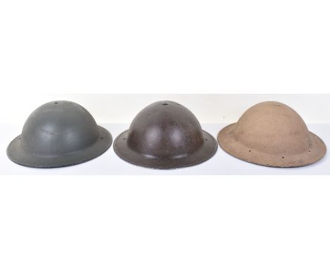 3x WW2 Steel Helmets, consisting of British steel helmet with much of the original paint remaining to the exterior. Interior 