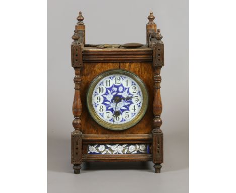 A Victroian oak cased eight day mantel clock with blue enamel dial decorated with flowers and having black Arabic numeral mar