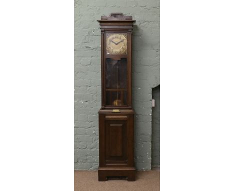 A 1940s oak eight day longcase clock with square brass dial having Arabic numeral markers and signed W. Greenwood.